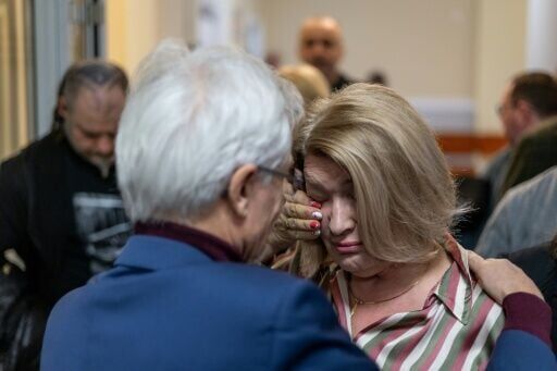 Lilianna Kupaj, who was abused by a Polish priest as a child, wipes away a tear in the courthouse