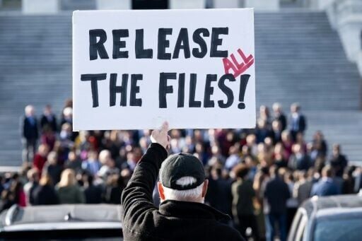 A protester holds a sign related to the release of the Jeffrey Epstein case files outside the US Capitol