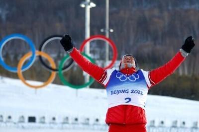 Alexander Bolshunov celebrates winning a cross-country skiing gold for Russia at the 2022 Beijing Winter Olympics