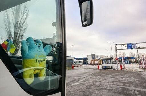 A bus at Palanca's border crossing with an "I love Ukraine" toy and the Moldovan and Ukrainian flags