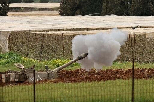 An Israeli self-propelled howitzer artillery gun fires rounds towards the southern Lebanon