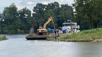 Barge opens mouth of Selma Marina; major dredging to start in October