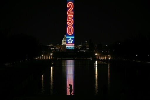 The Washington Monument is illuminated with a projection of US President Donald Trump's "Freedom 250" initiative during the New Year's Eve show at the National Mall in Washington, DC on December 31, 2025