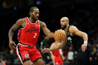 Kawhi Leonard of the Los Angeles Clippers dribbles past Minnesota's Rudy Gobert on his way to scoring 41 points in an NBA victory over the Timberwolves