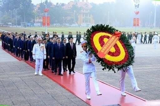A handout photograph released by the 14th National Congress via the Vietnam News Agency shows paying their respects at the Ho Chi Minh mausoleum in Hanoi