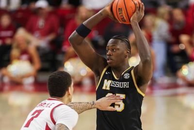 From left, Arkansas forward Trevon Brazile (7) defends Mizzou guard Mark Mitchell (25) (copy) (copy)