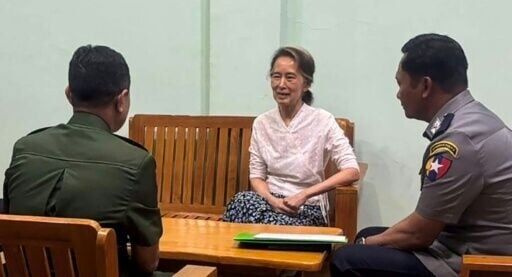 This undated handout photo from the Myanmar Military Information Team released on April 30, 2026 shows Aung San Suu Kyi (C) talking in an undisclosed location