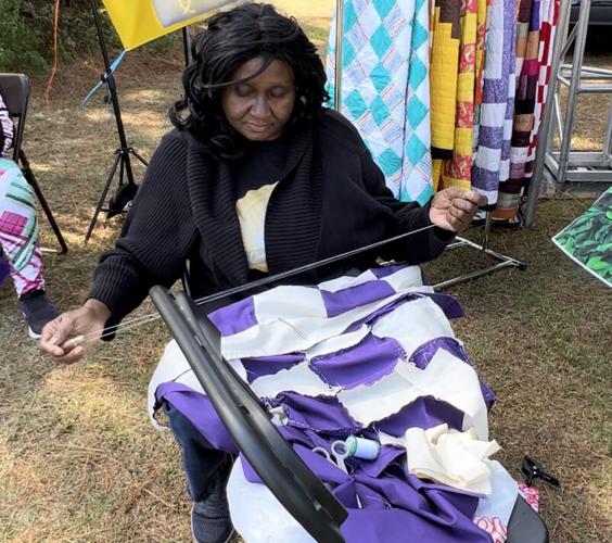 Gee's Bend quilters crowd for Airing of the Quilts Festival on