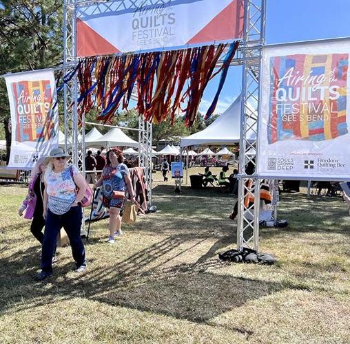 Gee's Bend quilters crowd for Airing of the Quilts Festival on