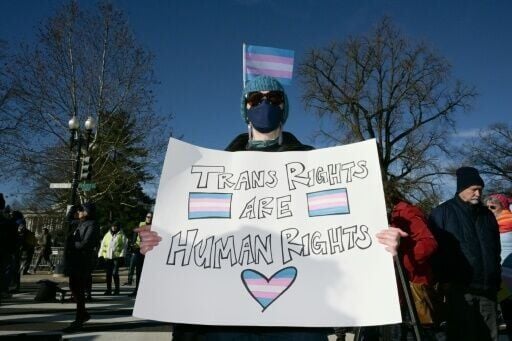 A supporter of transgender rights displays a sign outside of the Supreme Court