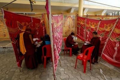 Buddhist monks prepare to cast their ballots at a polling station in Dharamsala in India durin the first round of voting on February 1, 2026