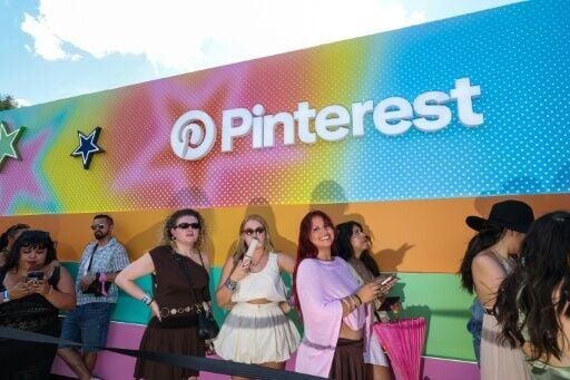 Festival-goers line up to get inside the activation booth of US social media service Pinterest during the 2026 Coachella Valley Music and Arts Festival