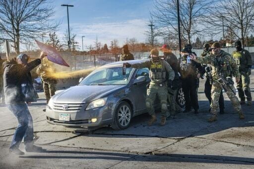 Federal agents use pepper spray against a protester outside an ICE facility in Minneapolis, Minnesota