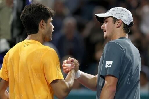 World number one Carlos Alcaraz of Spain shakes hands with Joao Fonseca after beating the Brazilian in the second round of the Miami Open