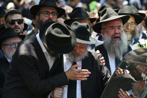 Mourners follow the hearse carrying the coffin of rabbi Eli Schlanger, who was killed in the December 14 Bondi beach shooting attack, after his funeral service at the Chabad of Bondi Synagogue in Sydney on December 17, 2025