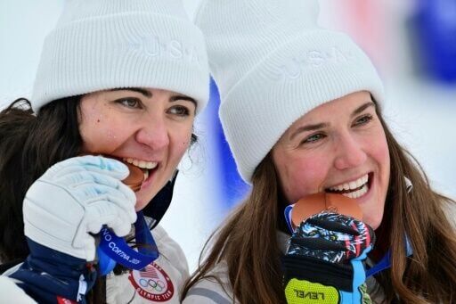 USA pair Jacqueline Wiles (L) and Paula Moltzan pose after claiming bronze in the women's team combined event during the Milan-Cortina 2026 Winter Olympics