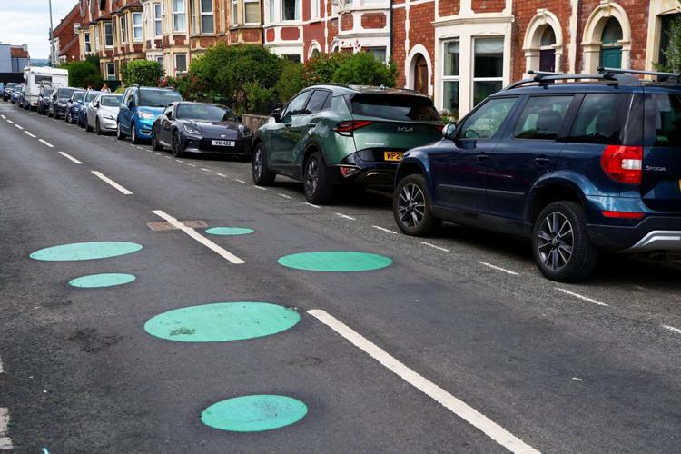 Mystery green spots on road leave residents baffled