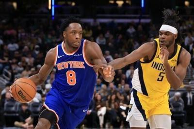 O.G. Anunoby of the New York Knicks drives to the basket against Jarace Walker of Indiana in a Knicks' NBA triumph at Indianapolis