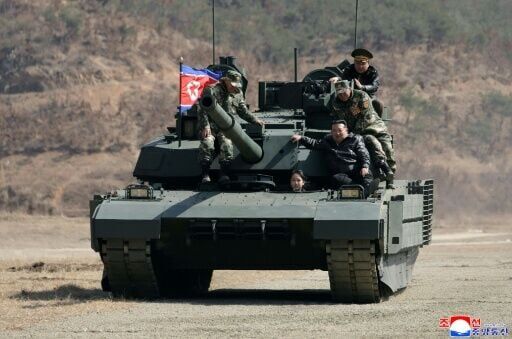 North Korean leader Kim Jong Un and his daughter Kim Ju Ae board a tank