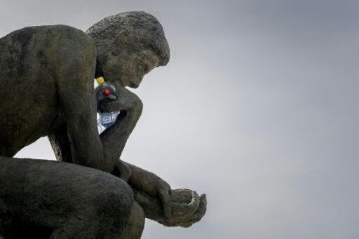 A 'Thinker' drowns in plastic garbage as UN treaty talks open