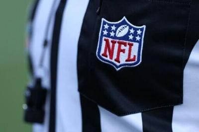 A referee wears an NFL logo at Super Bowl 60. If NFL referees have a work stoppage and a new contract is not signed with the league, new rules will allow league officials to help replacement referees avoid major mistaken calls during games