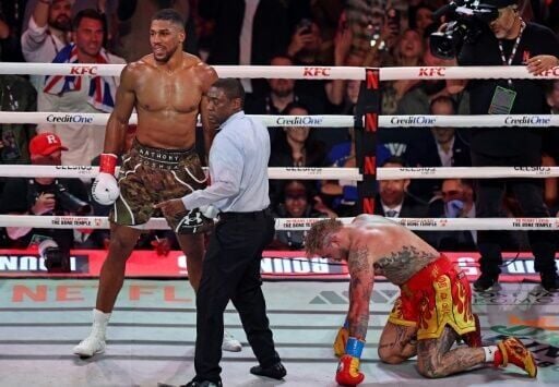 Anthony Joshua knocks down Jake Paul in their Netflix-backed heavyweight fight in Miami