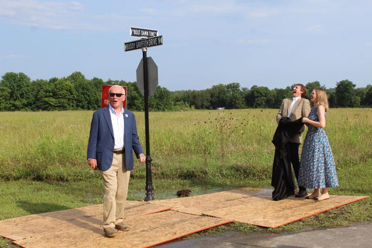 Laughing with sign for 'Bout Damn Time'