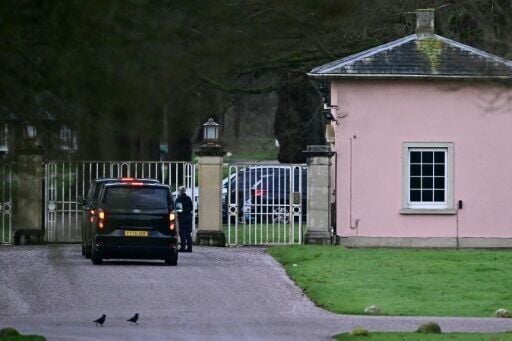 Cars wait at the entrance to Royal Lodge, the old residence of Britain's former prince Andrew where police said they are still conducting a search