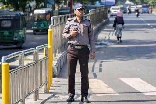 A Bangladesh police officer wears the new grey and brown uniform in Dhaka, but critics doubt whether the change in colours will mend the force's shattered reputation