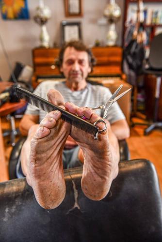 Barefoot barber stopped wearing shoes 20 years ago – even at work