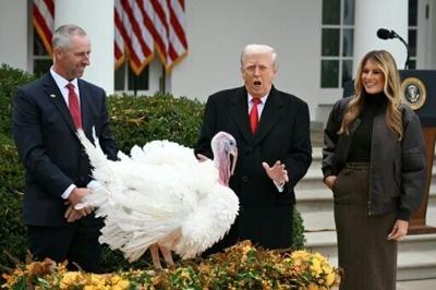 First Lady Melania Trump looks on as US President Donald Trump pardons Gobble, one of the National Thanksgiving turkeys, during a ceremony in the Rose Garden