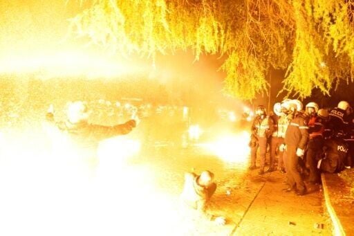 Protesters clash with anti-riot police during an anti-government protest in Tirana on February 10, 2026