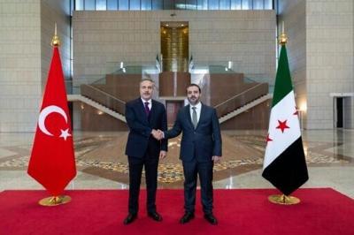 This handout photograph provided by the Turkish Foreign Ministry press service shows Turkish Foreign Minister Hakan Fidan meeting with his Syrian counterpart Asaad al-Shaibani in Damascus