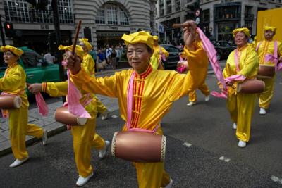 Falun Gong practitioners march in London, calling for an end to persecution by the Chinese Communist Party.
