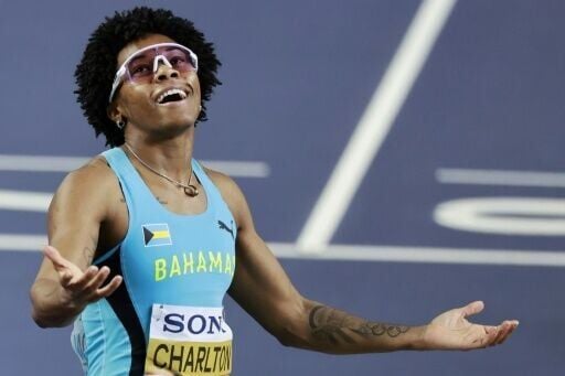 Bahamas' Devynne Charlton celebrates winning the 60m hurdles
