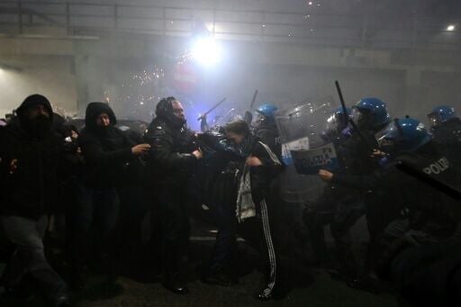 People clash with police during a protest against the environmental, economic and social impact of the Milano-Cortina 2026 Winter Olympics Games, in Milan on February 7, 2026.