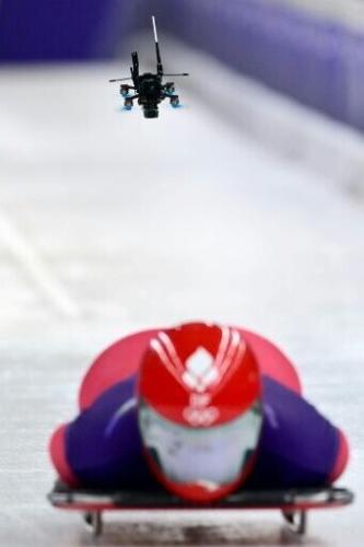 A drone follows Denmark's Nanna Johansen as she takes part in the skeleton women's training session at Cortina Sliding Centre