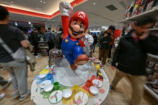 Customers walk past a display for Super Mario by the Japanese gaming company Nintendo, at the company's official store in Tokyo's Shibuya district