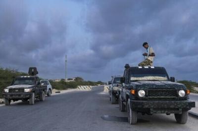 Somalian security officers pray at a security checkpoint on the outskirts of Mogadishu