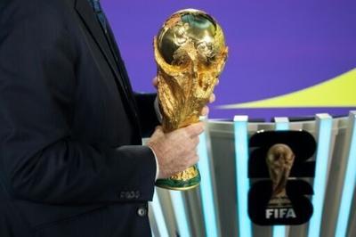 FIFA President Gianni Infantino holds the FIFA World Cup trophy