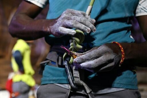 An Indian climber with his hands covered in chalk