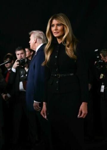 US first lady Melania Trump looks on as US President Donald Trump speaks to journalists at the world premiere of Amazon MGM Studios' "Melania" at the Kennedy Center in Washington