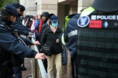 Visitors enter a court in Hong Kong on January 22 for the start of the trial of leaders of the now-disbanded Hong Kong Alliance