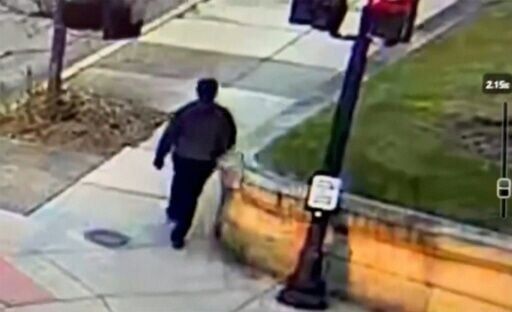 This video grab from a CCTV footage released by the Providence Police Department shows the suspect in the Brown University shooting walking along a road near the campus in Providence