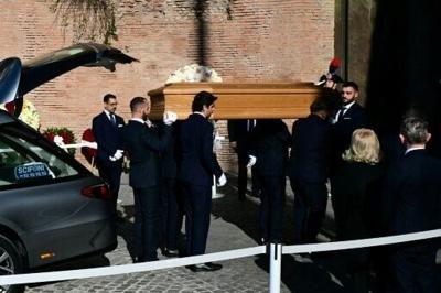 Pallbearers carry the coffin of the late Italian fashion designer Valentino Gavarani to enter the Basilic of Santa Maria degli Angeli e dei Martiri for a funeral ceremony, in Rome on January 23, 2026.