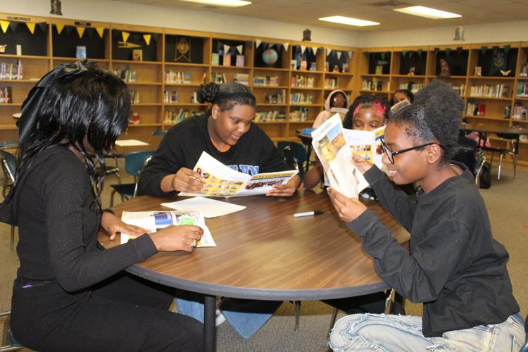 Keith High library reads paper