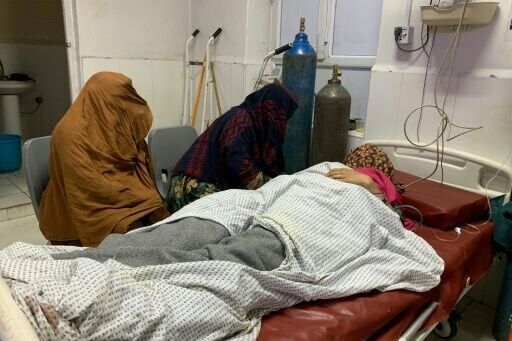 A wounded Afghan woman receives treatment at a hospital in Jalalabad after an overnight Pakistani mortar shell hit a camp for people returning from Pakistan