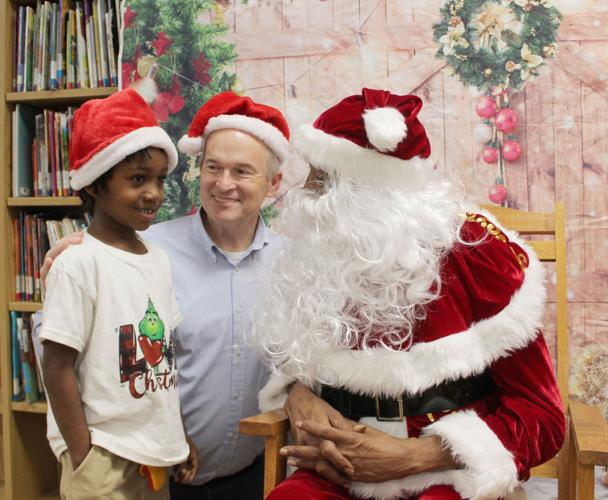 Doug smile with Santa and child.JPG