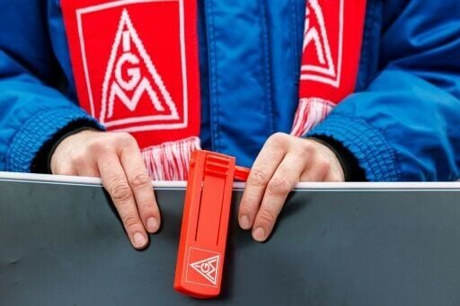 A VW employee wearing an IG Metall union scarf at a rally in eastern Germany