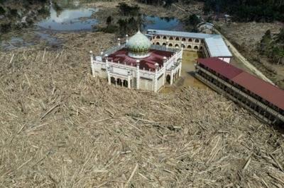 An aerial view shows vast remains of uprooted trees at the Darul Mukhlisin Islamic boarding school and mosque in the aftermath of flash floods at Aceh Tamiang